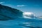 Ideal surfing wave in Atlantic ocean. Blue glassy barrels and sky