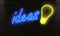 ideas and bulb neon light on a night alley on a brick wall brain
