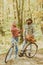 Ideas for perfect autumn date. Couple in love ride bicycle together in forest park. Romantic date with bicycle. Bearded