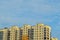 Identical high-rise buildings. Same type apartment buildings against a blue sky