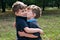 Identical twin brothers embraced each other with a kiss