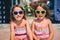 Identical twin girls on summer vacation posing for camera.