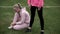 Identical twin sisters in sportswear train outdoors, one of them ties shoelaces