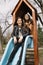 Identical twins having fun on slide in playground