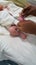 Identification tag being put on the feet of new born infant in hospital
