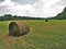 Idle Tractor behind Baled Hay