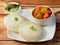 Idli or idly is a healthy Indian, vegetarian, traditional and popular steam cooked rice cakes served with bowls of chutney and