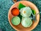 Idly sambar or Idli with Sambhar and green, red chutney. Popular South indian breakfast