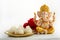 Idol of lord Ganesha with Modak Sweet Dish and flower. Ganesh chaturthi