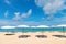 Idollic beach relaxing concept with white parasols on sand