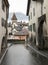 Idyllic alpine village in Switzerland with a vlilage road leading through old building and many roofs in the background