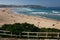 Idyllic and amazing seaside landscape on Bondi Beach of white rushing ocean waves and oceanfront hillside buildings