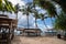 Idyllic beach restaurant with wooden tables and benches and white umbrellas