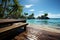 Idyllic beachfront view, wooden platform, palm trees, crystal-clear waters, blue skies