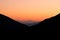 Idyllic beautiful landscape of sunset between mountains highland space with clear orange sky, wallpaper pattern and copy space