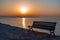 Idyllic bench at sunriset time on the pier