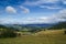 Idyllic and calm Alp scenery: the worldfamous alp de Siusi in the dolomites. Green meadow and a blue sky with some white clouds. s