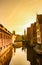 Idyllic cityscape of a bridge and canal in golden sun in Ghent, Belgium, Europe