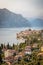 Idyllic coastline in Italy: Blue water and a cute village at lago di garda, Malcesine, sunset