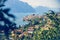 Idyllic coastline scenery in Italy: Blue water and a cute village at lago di garda, Malcesine