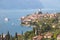 Idyllic coastline scenery in Italy: Blue water and a cute village at lago di garda, Malcesine