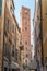 Idyllic cobblestone lane lined with quaint buildings in Noli, Liguria, Italy