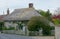 Idyllic Cottage with thatched roof in rural village, UK.