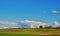 Idyllic country landscape with blue sky and cumulus clouds