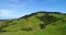 Idyllic countryside farmland nature and hills with Sheep on grass in New Zealand