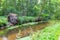 Idyllic creek with curved trees over the river for hiking-tours and canoe trips in a protected landscape on a calm river