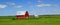 Idyllic farmland scenery: Red barn within green fied