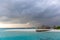 An idyllic island in Maldive in a stormy weather afternoon. Super clear water, white sand, traditional huts and tropical climate f