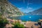 Idyllic Lake Garda above Limone sul Garda old town with boat, Italian alps