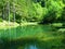 Idyllic lake Kreda near Mojstrana in Vrata valley, Slovenia and a reflection of the trees in the lake