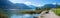 Idyllic lake shore Achensee Buchau, with walkway, boats at the water, mountain view tirol