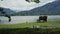 Idyllic lookout point at lake Tegernsee with bench, mountain landscape, ducks