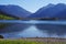 Idyllic mountain lake with an excursion boat framed by high mountains