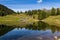 Idyllic mountain lake with some huts on an alp in Austria