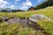 Idyllic mountain landscape in the alps: Mountain chalet, meadows and blue sky