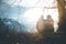 Idyllic mountain sundown scenery: Young sitting couple enjoys the view