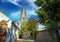 Idyllic narrow old alley in small Dutch village with medieval church tower - Thorn, Limburg, Netherlands