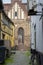 Idyllic narrow street with old houses and a church in the background