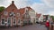 Idyllic old houses in Greetsiel, a small picturesque fishing town in North Frisia. Some Tourists walking around shortly