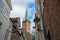 Idyllic old town alley with the tower of the Petri church in the historic center of the hanseatic city of Lubeck, Germany