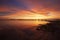 Idyllic orange sunrise on the beach of Los Urrutias, in the Mar Menor, Cartagena, Region of Murcia