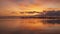 Idyllic orange sunrise on the beach of Los Urrutias, in the Mar Menor, Cartagena, Region of Murcia