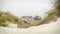 Idyllic and quaint beach houses seen from beach dunes. Beach houses with colorful stripes from Costa Nova, Portugal.