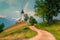 Idyllic rainbow landscape with Saint Primoz church, near Jamnik, Slovenia