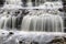 Idyllic river landscape featuring a rocky riverbed and surrounding boulder-strewn banks