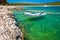 Idyllic rocky beach Sakarun and small boat on Dugi Otok island